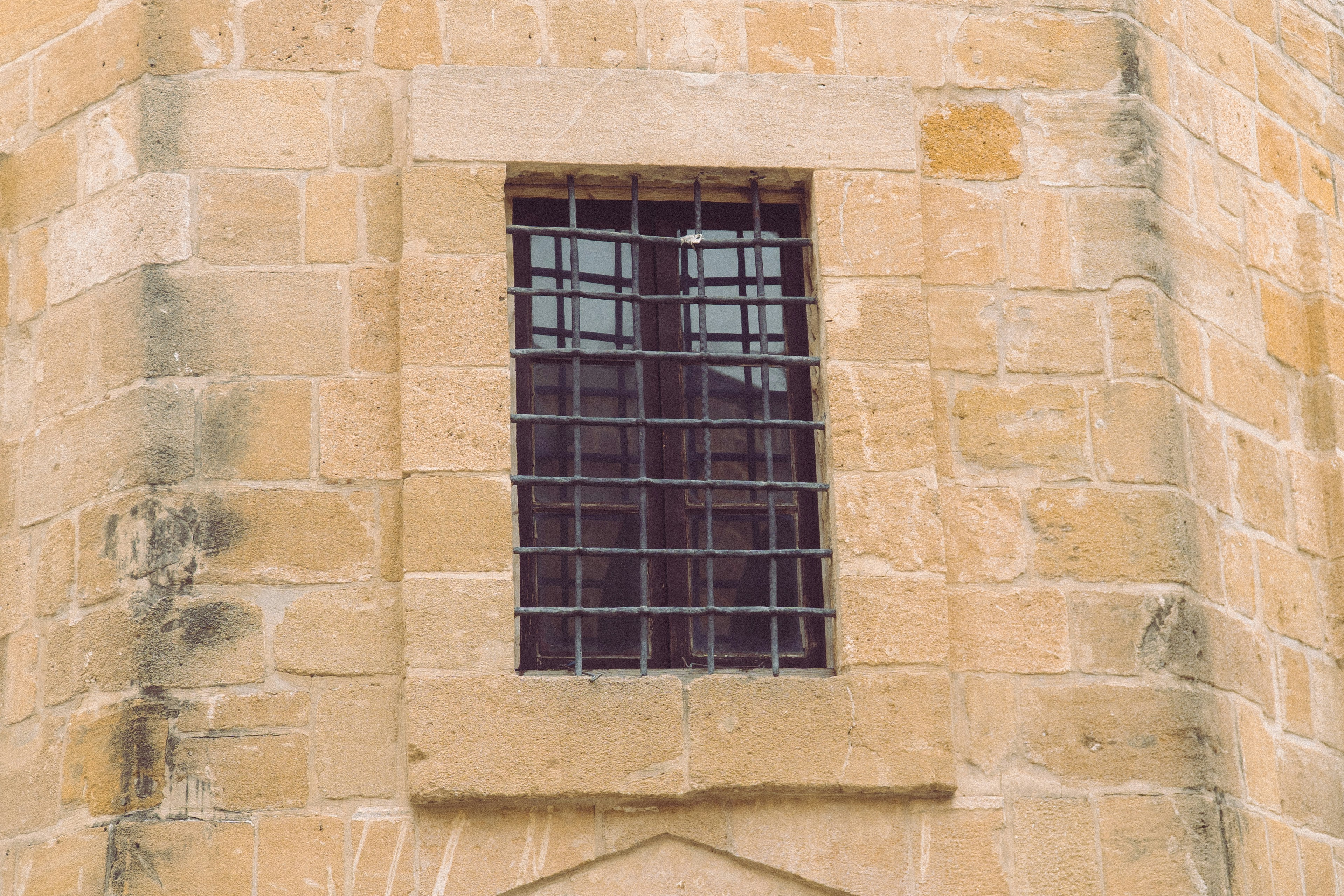 Stone wall with a barred window